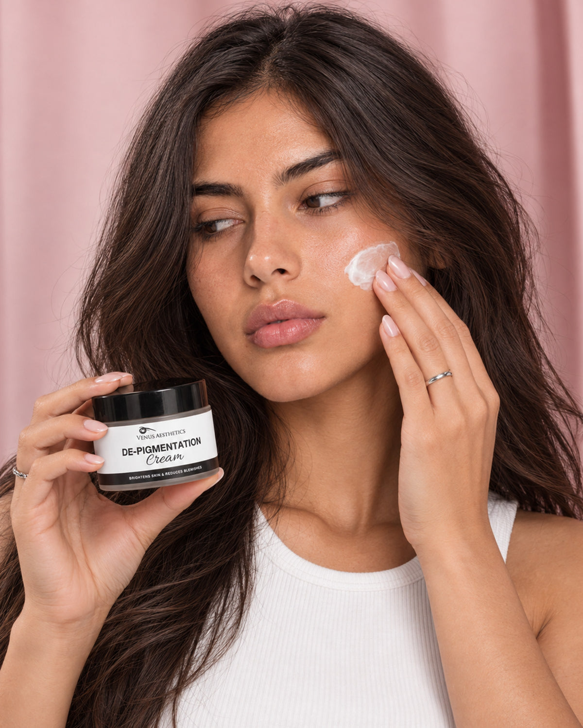 Model holding the Venus Aesthetics De-Pigmentation Cream