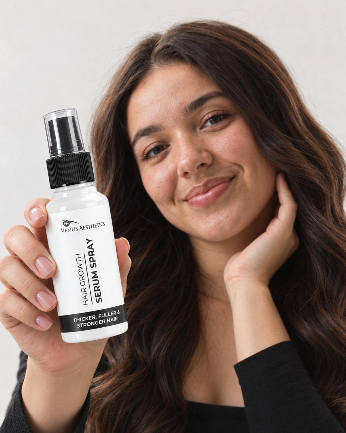 Model holding the Venus Aesthetics Hair Growth Serum Spray